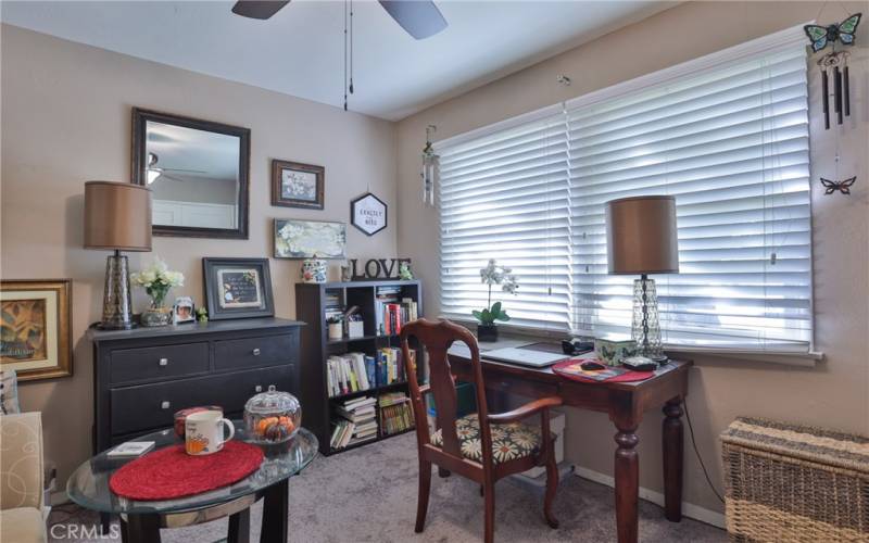 Each bedroom has carpet and a ceiling fan. This one has 1 large window and the other one has two windows. This room is currently being used as an office.