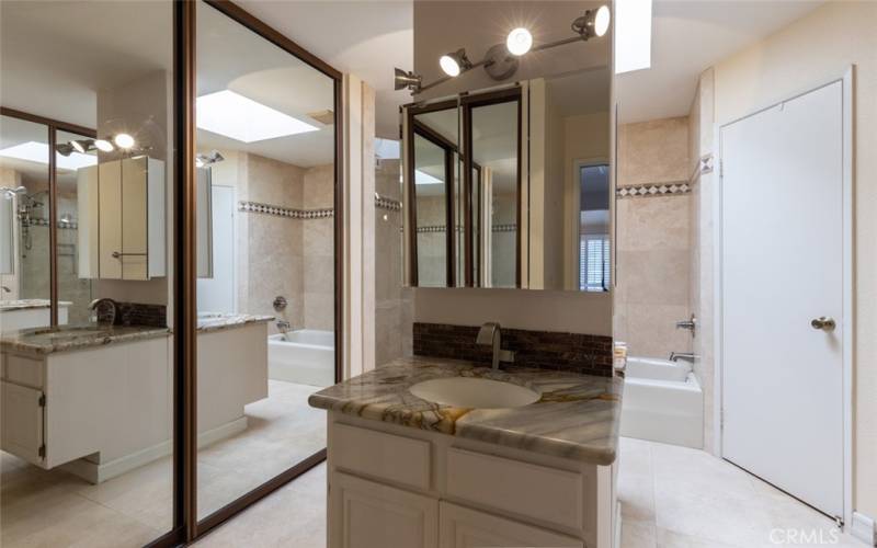 And spa-like bathroom with dual facing vanities, plenty of closet space, walk-in shower, tub and separate lavatory.