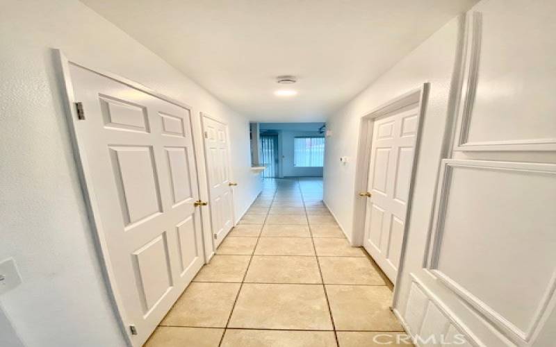 Hallway view from primary bedroom to the living room/ kitchen area.