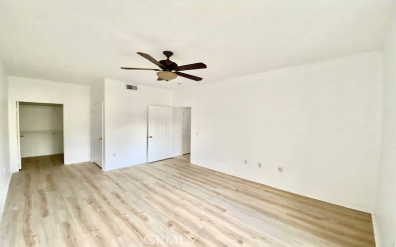 Large primary bedroom has brand new flooring and a large walk in closet.