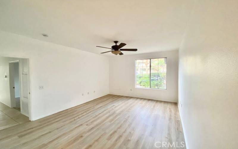 Primary bedroom has a large window, allowing ample natural light.