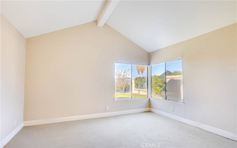 Primary bedroom with vaulted ceilings