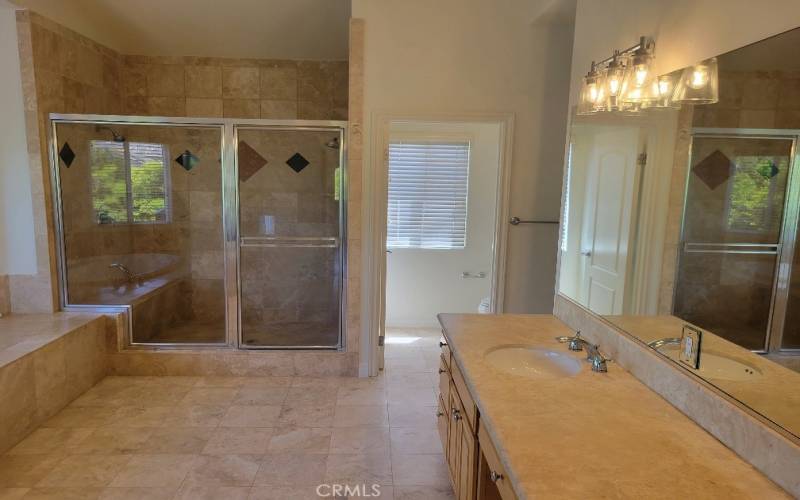 Another view of primary bathroom with two showers