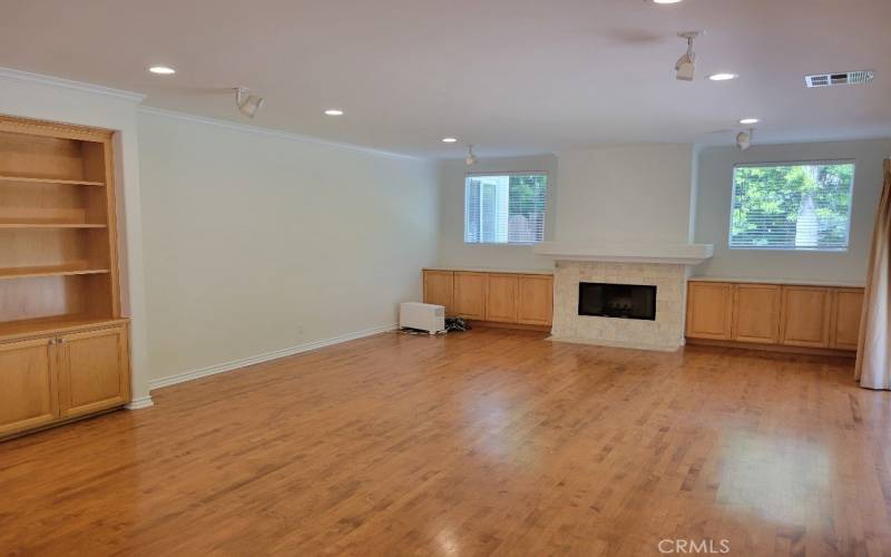 Main level family room with a fireplace and built-ins