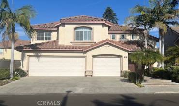 
This two-story Mediterranean-style home features a well-maintained stucco exterior complemented by a tile roof, offering classic Southern California curb appeal. The property includes a three-car garage, providing ample parking and storage space. The symmetrical design and arched window accents enhance its aesthetic charm, while the landscaped surroundings, with mature palm trees and manicured shrubs, create an inviting atmosphere. Situated on a quiet street, the home exudes pride of ownership and is pe...