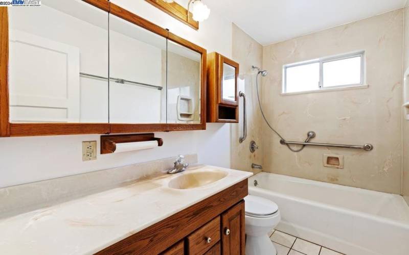 Bathroom with shower over tub