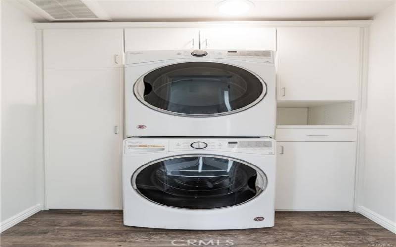 New stackable washer /dryer in separate closet w/ additional storage space