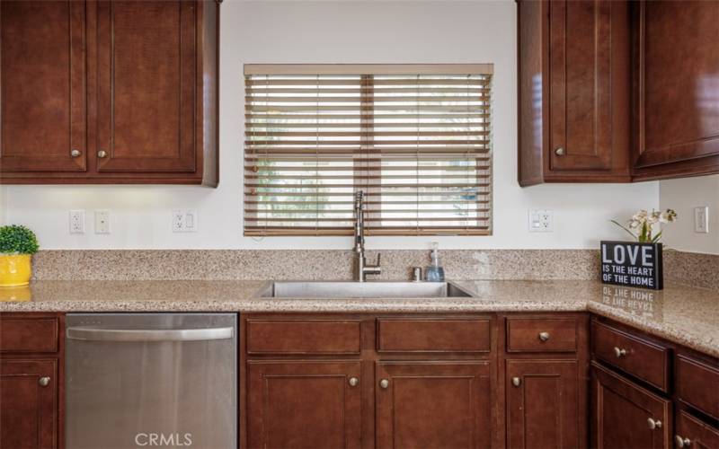 Kitchen with farmhouse style sink and window to the outdoor.