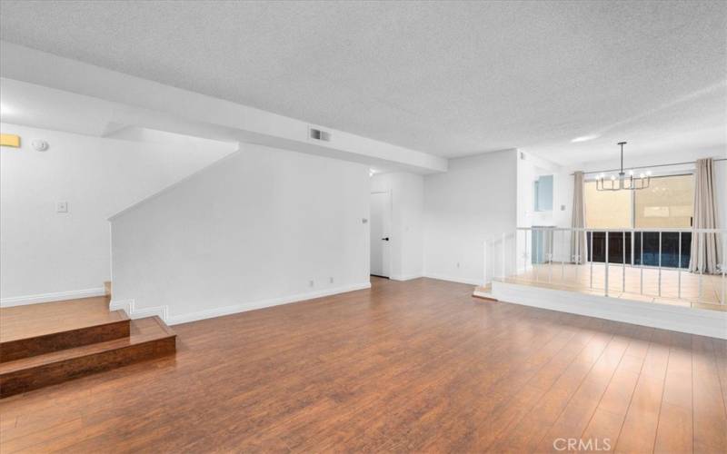 living room leads upstairs to two bedroom suite and downstairs to garage, laundry and bonus room