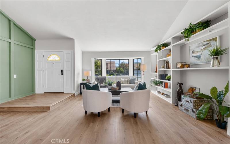 Entry and living room with built-in cabinets.