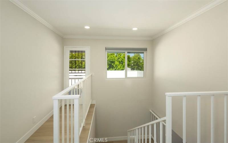 At top of the stairs is the deck entrance for the secondary bedrooms or visitors.