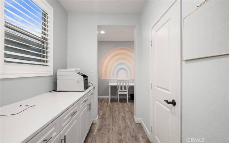 butler's kitchen space with storage- pantry and look into mud room