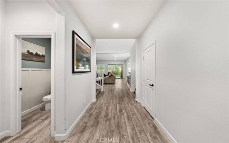 Entrance - long hallway and guest powder room