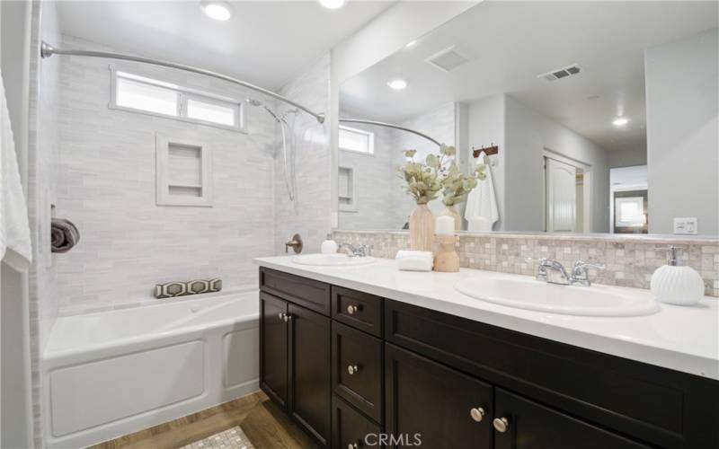 Primary Bathroom with dual sinks and jetted tub