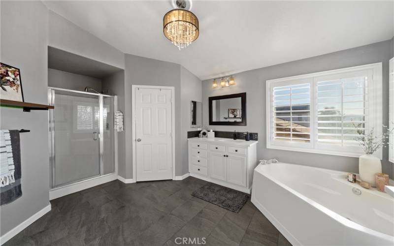 En suite features soaking tub, separate shower and two vanity areas