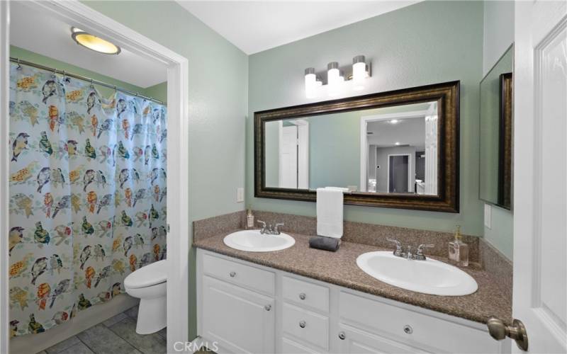 bathroom located next to (3) with separate vanity area and shower/tub combo