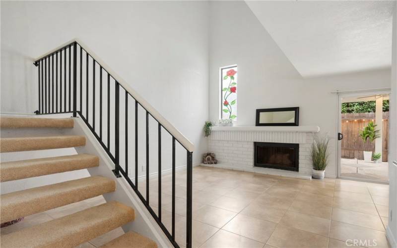 Living Room with Stained Glass Window and Brick Fireplace