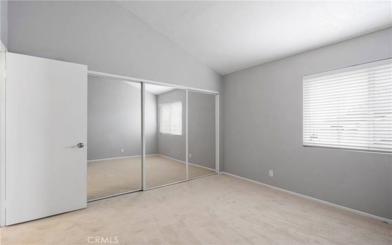 First Bedroom with Mirrored Wardrobe Doors and High Ceilings