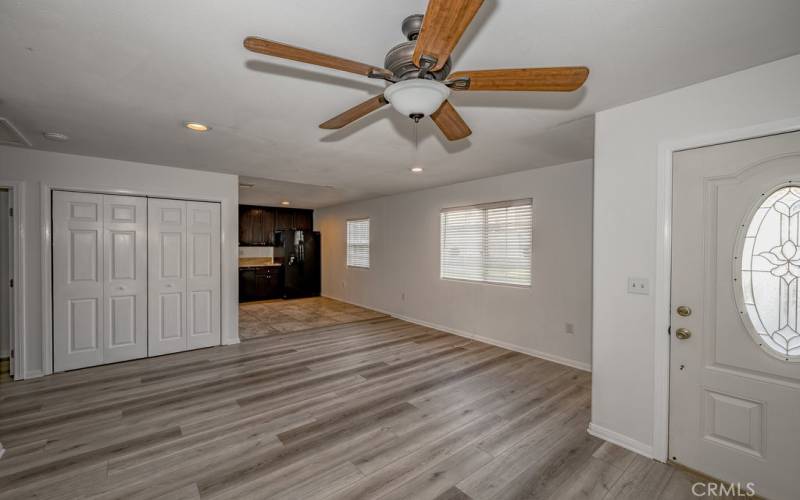 Living room with view to dining area under large window