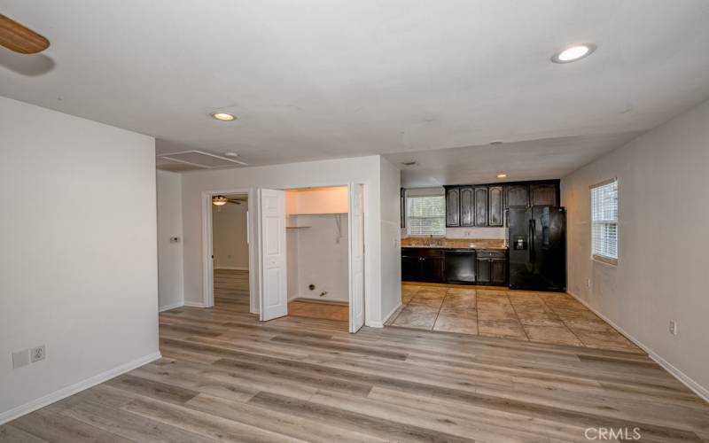 Living room with view to laundry closet, kitchen and one bedroom