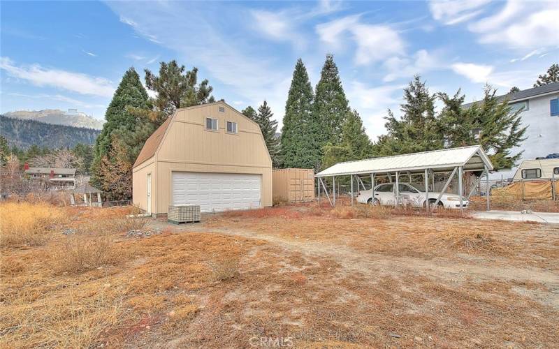 Carport, two car garage, and shipping container for storage and still plenty of space in the yard.