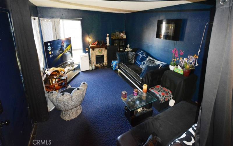 View of the Spacious Living Room which offers two floor to ceiling windows.