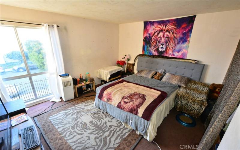 Large Main Bedroom with floor to ceiling windows overlooking the street