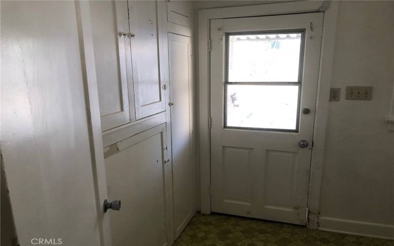 Laundry Room storage and door to backyard.