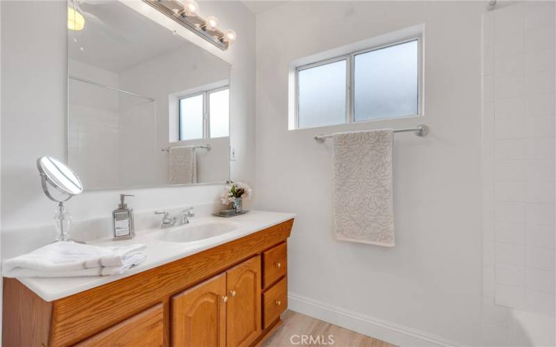 Main bath  white tile and white tub