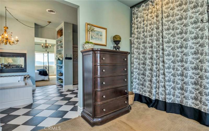 Looking from dressing area back through bathroom and into bedroom.