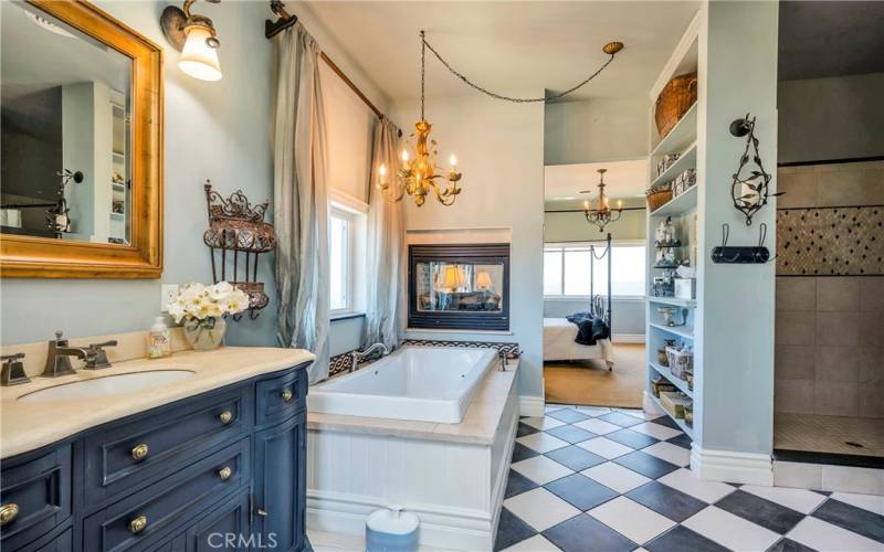 Double-sided fireplace at the foot of the soaking tub.