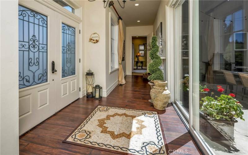 This stunning inlaid tile mosaic graces the already beautiful entryway, with the atrium just on the other side of the glass sliding doors.