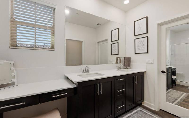 Beautiful spa-like bathroom features quartz countertops, a dual vanity, custom cabinets and a spacious walk-in closet.