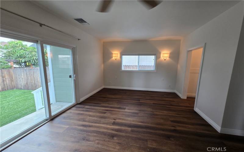 Primary bedroom with access to the private backyard.