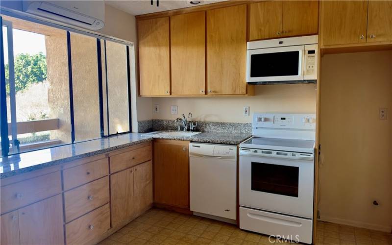 Non Virtual picture, close up of the kitchen. Water purfier, larger stove then most studio units, microwave, dishwasher, large sink, updated countertops.