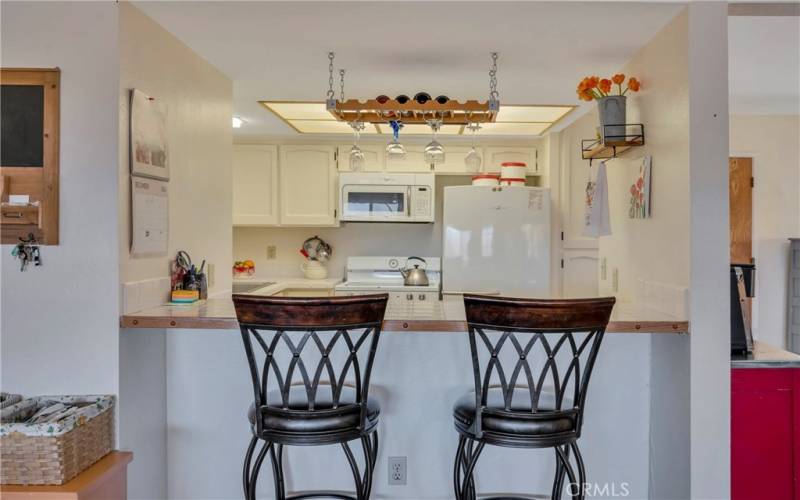 Kitchen features an eat-in bar area.