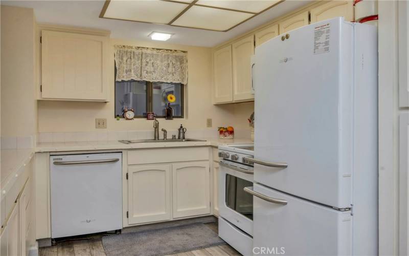 Kitchen has an eat-in counter on the left of this picture  that opens to the living room