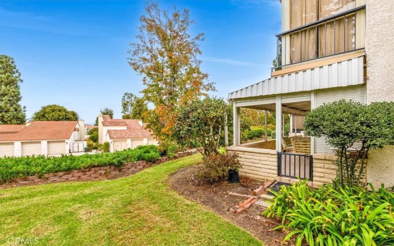 The back patio is surrounded by lush landscaping you get to enjoy but not have to maintain!