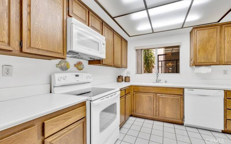 Functional kitchen with window overlooking the front garden & entrance.