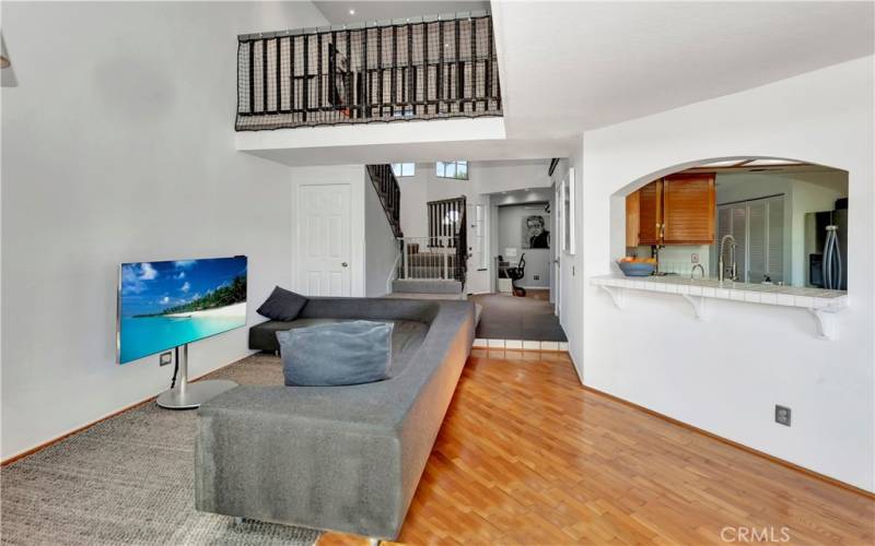 Living Room and view of stairway, entrance and kitchen.