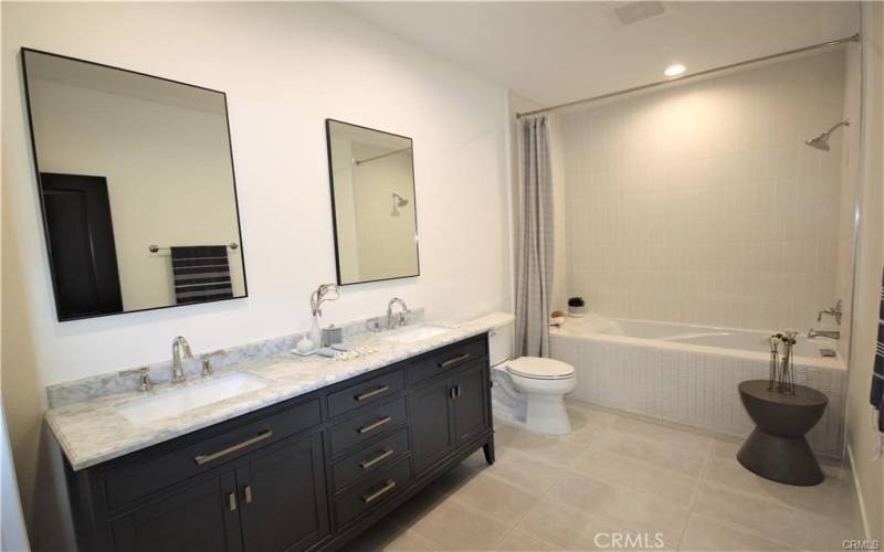 Beautiful larger bathroom with tile floors and storage for niche for all your essentials.