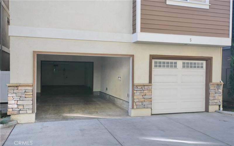 2 single car garage and one carport.   One garage door open in this picture.