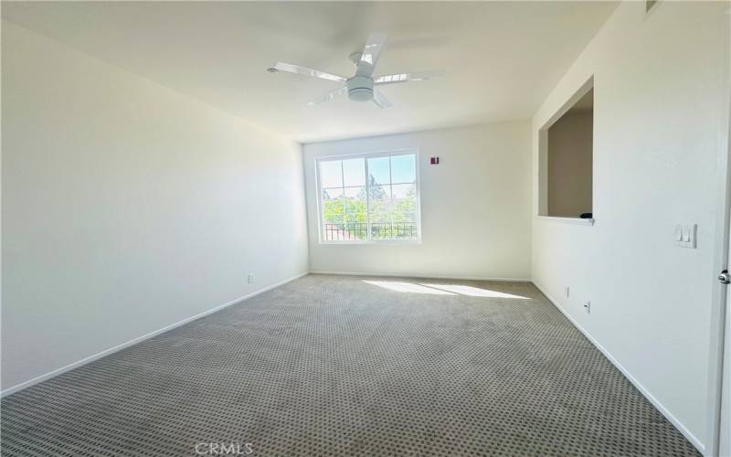 Spacious primary bedroom with lots of natural light