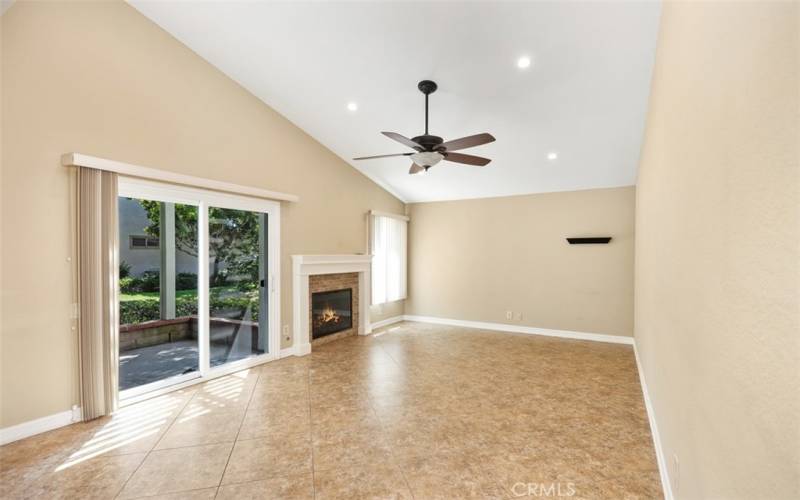 Large living room with fireplace vaulted ceilings with updated windows and doors through out