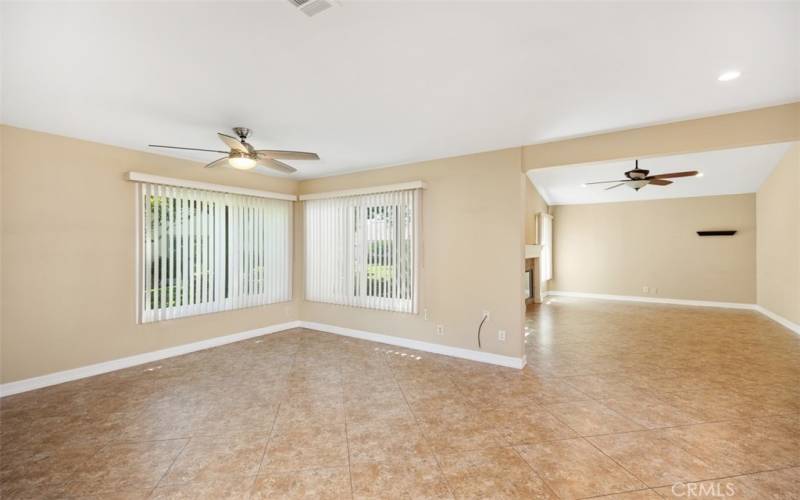 Spacious dining room with open floor plan leading to living room