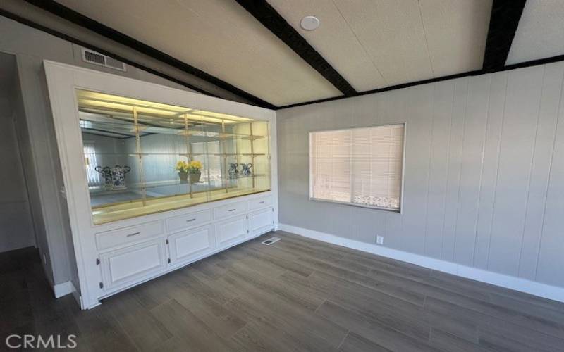 Dining room with a built in china cabinet and lighting.