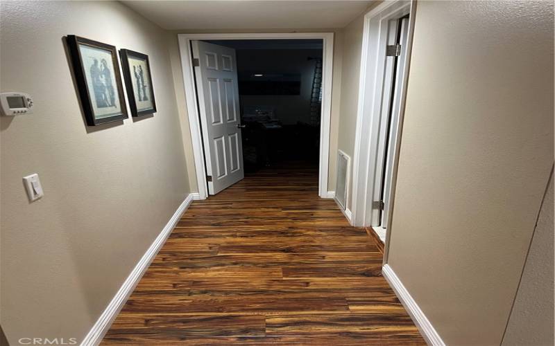 Downstairs hall leading to bedroom and bathroom on second level.