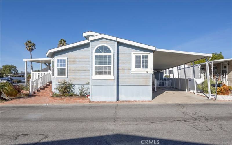 Side view of the house with a view of the carport.