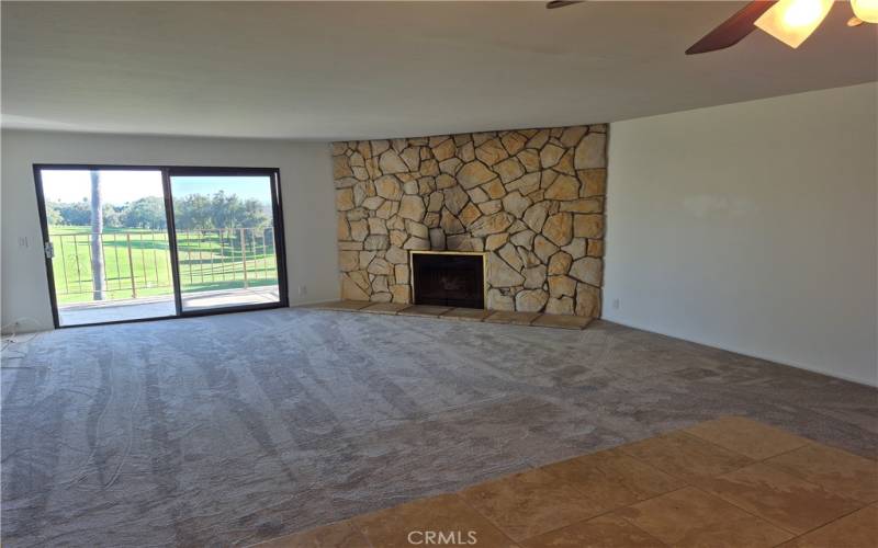 Living room with gas fireplace & slider to balcony