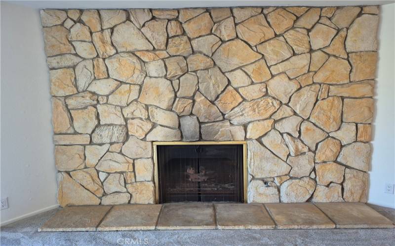 Large stone gas burning fireplace